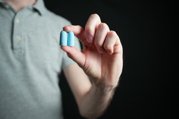 Fototapeta premium Man showing blue silicone ear plugs 