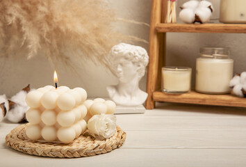 Obraz na płótnie Canvas Cozy decor and burning candles against the backdrop of a minimalist interior. Trendy Bubble candles with vanilla flavor. Eco soy candles. Candles for relaxation. Close-up. Place for text. Interior. Hy