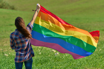 Woman with Rainbow flag on pathway