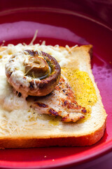 slice of  toast bread grilled with meat, champignon and cheese
