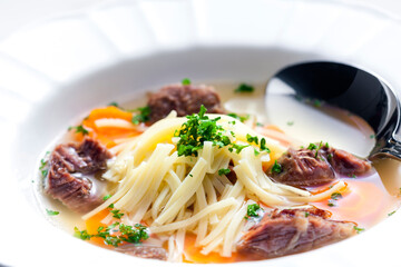 beef broth with noodles and carrot