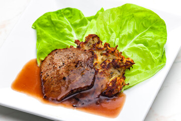 beef steak with sauce served with potato pankcakes