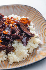 beef meat with soya sauce and peanuts served with white rice