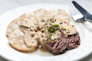 beef meat with mushroom sauce and dumplings