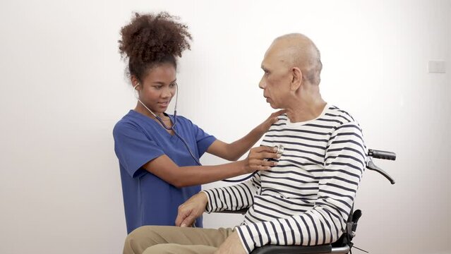 Doctor nurse black woman in blue uniform talks, encourages and checks a cancer patient. World Cancer Day. - Powered by Adobe