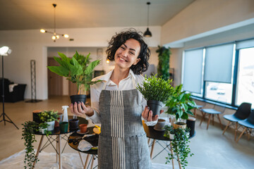 portrait of woman mature caucasian female take care of plants at home