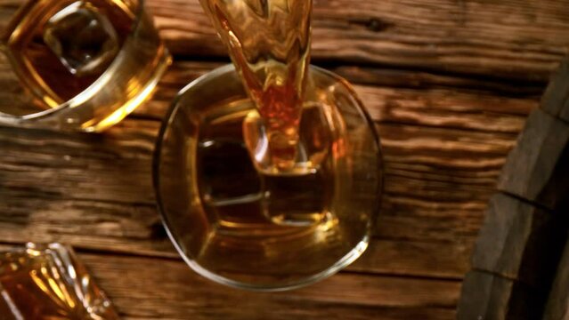 Super slow motion of pouring whiskey or rum with camera motion. Filmed on high speed cinema camera, 1000 fps.