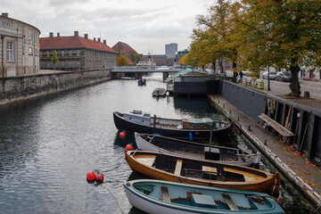 Top view group of small boats docks on the canal in Copenhagen, Denmark in autumn season.