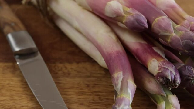 fagot d'asperges violettes, en gros plan, sur une table