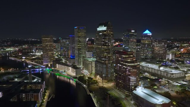 Night urban landscape of downtown district of Tampa city in Florida, USA. Skyline with brightly illuminated high skyscraper buildings in modern american megapolis