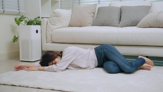 Young Asian woman with depression and fainting in living room at home