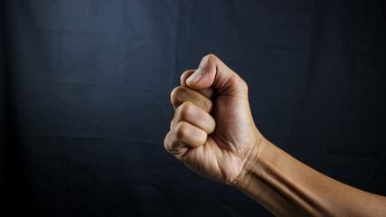 Counting, aggression, brave concept. Black male fist, clenched hand, strong male man raised fist...