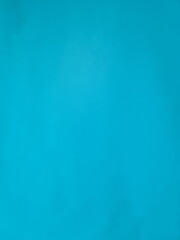 Plastered of cement wall are painted turquoise blue to be used as wallpaper. A vintage-style blank blue wall is perfect for advertising. Empty space on the wall is painted in bright blue. wall texture