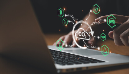 Entrepreneur hand point at digital screen dashboard while control and reduce carbon emission for global friendly business. Business with environment concern, carbon credit and zero emission.