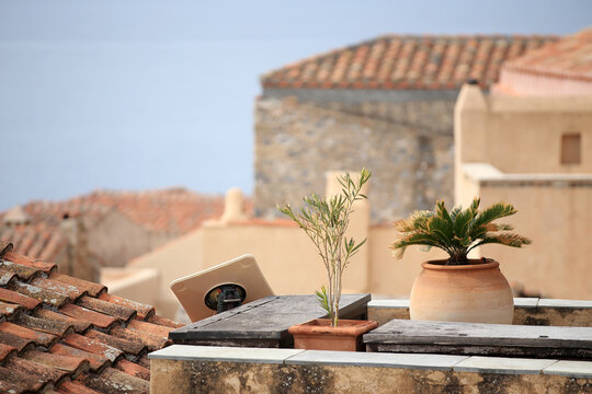 Monemvasia (Peloponnese, Greece) - Past and present: satellite dish and plants on the roof of a medieval tenement house...