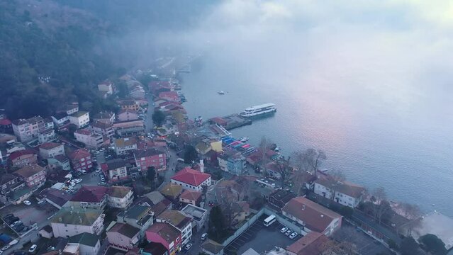 Anadolu Kavagi resort town in Istanbul, Turkey. A fog bank covered the whole Bosphorus like a cotton quilt. Aerial view

