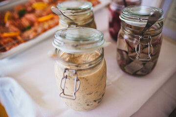 Glass jars filled with herring.