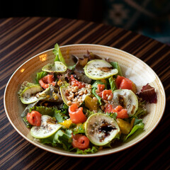 Salad with salmon, pine nuts and vegetables. Seafood dishes. Vegetarian food. healthy diet. View from above. Dark brown background. Copy space. 