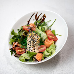 Salad with fresh vegetables, arugula and salmon. Vegetarian dish. Light dinner. Healthy diet. Healthy lifestyle. White background. Top view. Copy space.