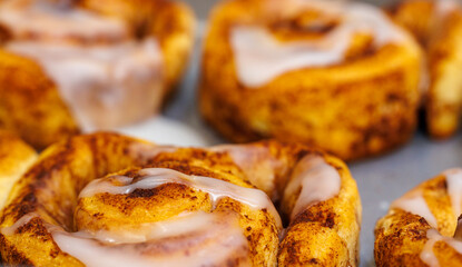 Close up cinnamon bun with white frosting glaze