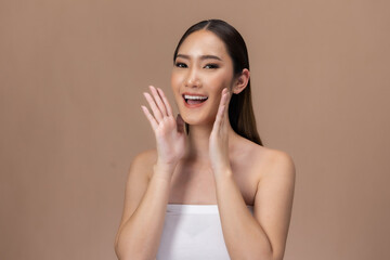 Beautiful Asian woman touching eyebrow smile with clean and fresh skin Happiness  with positive emotional,isolated on Beige background,Beauty Cosmetics and spa Facial treatment Concept.