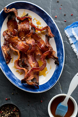 A dish filled with sweet and savoury maple peppercorn bacon, ready for eating.