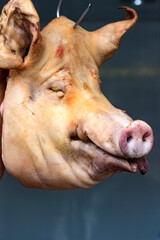 Pig's head in a butcher's shop. Sale of meat and semi-finished products. Pork.