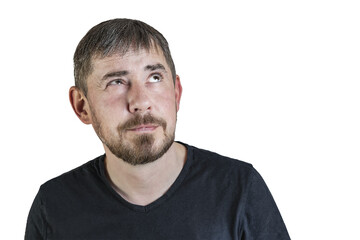 Fototapeta premium Portrait of an attractive bearded man of European appearance, with a slight gray hair, on an isolated white background. He looks up thoughtfully. Expression of emotions of a man.