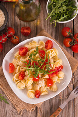 Orecchiette pasta with arugula and tomato.