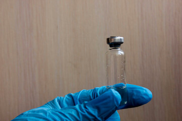 Concept of controlling the coronavirus virus, doctor or scientist in the laboratory holds a syringe with liquid vaccines for children or the elderly, concept: disease, medical care, science.