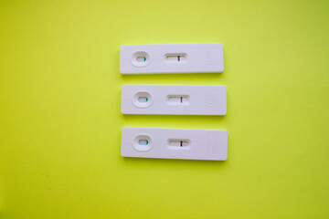 Three negative pregnancy tests on a yellow background. Motherhood, children, pregnancy, the concept of birth control. Health problems and problems with conception. abortion. Copy space