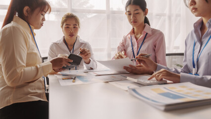 Close up brainstorming of asian businesswoman, bookkeeping, industrial sector of government partnership company, colleague working together to check audit, balance sheet to prevent fraud and bribery