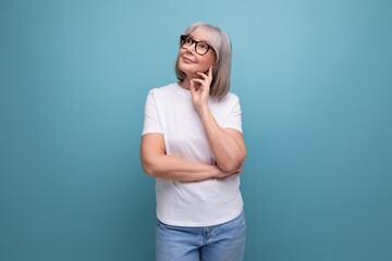mature woman in gray hair being premenopausal in studio background