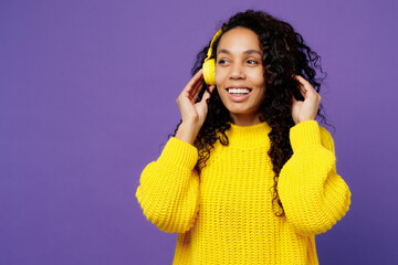 Young smiling happy minded woman of African American ethnicity wear casual yellow sweater...