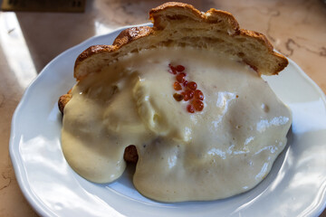 Eggs Royale croissant filled with 
whipped cream and salmon and decorated with caviar.