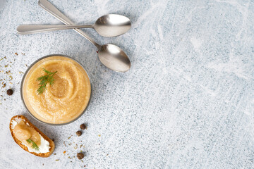 Glass with delicious caviar of capelin and crouton on grey background