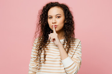 Young secret woman of African American ethnicity she wear light casual clothes say hush be quiet...