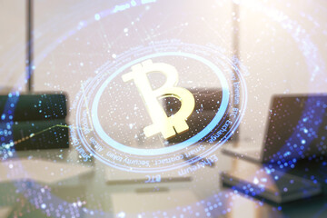 Double exposure of creative Bitcoin symbol and modern desktop with laptop on background. Cryptocurrency concept