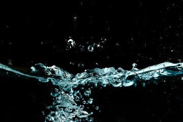 Water surface with bubbles on black background.