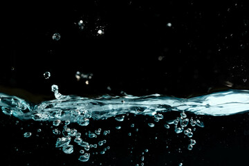 Water surface with bubbles on black background.