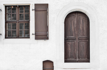 View of white building with wooden windows