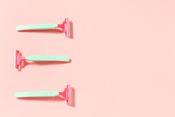 Safety razors on pink background