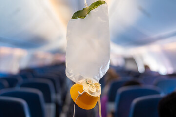 oxygen mask drop from the ceiling compartment on airplane..