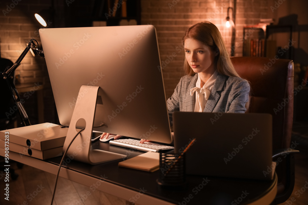 Wall mural female programmer working with computer in office at night