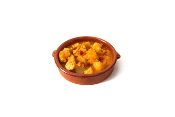 Potato stew with cod, served in a clay bowl. Isolated on white background. Spanish food concept.