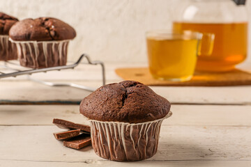 Tasty chocolate cupcakes on table