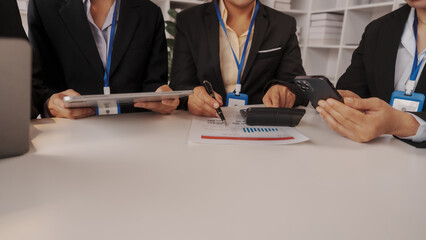 Group of four asian business people only women bookkeepers brainstorm in a meeting plan development, audit, balance sheet, manager and an employee communicating with full team.