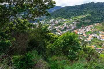 Madeira. Vereda da Boca do Risco. View of Machico village, located between green hills. Madeira Island, Portugal.