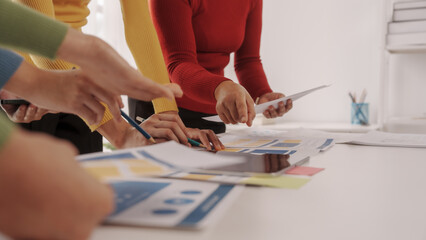 Group of ui ux developer brainstorming website wireframe mobile interface design on desk table.