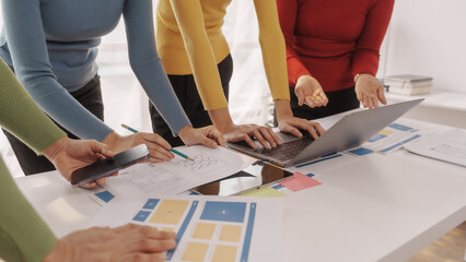 Group of ui ux developer brainstorming website wireframe mobile interface design on desk table.